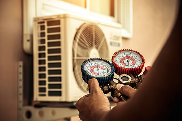 Professional Air Conditioning Service technician working in Helenville, WI